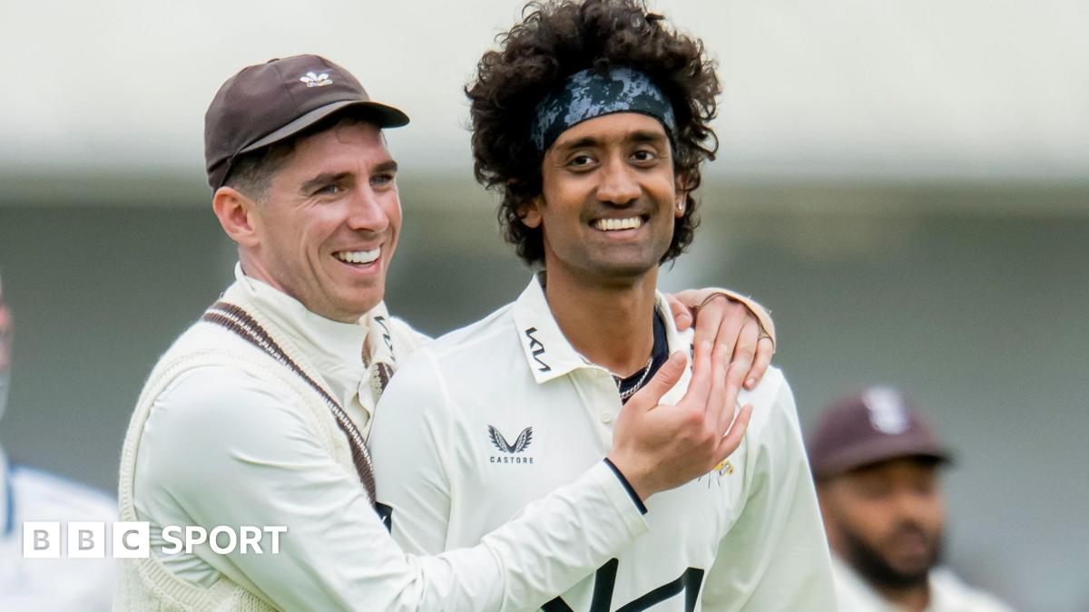 Dan Lawrence has his arms around Surrey team-mate Sai Kishore