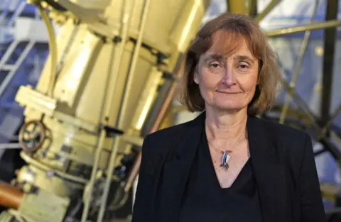 Amanda Clark/Cabinet Office Michele Dougherty in smart black suit standing in front of telescope.