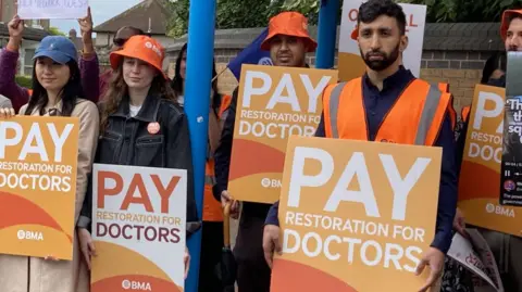 BBC Dr Shivam Sharma, right, at a picket line