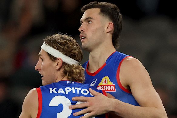 Sam Darcy of the Bulldogs is congratulated by Aaron Naughton after kicking a goal.