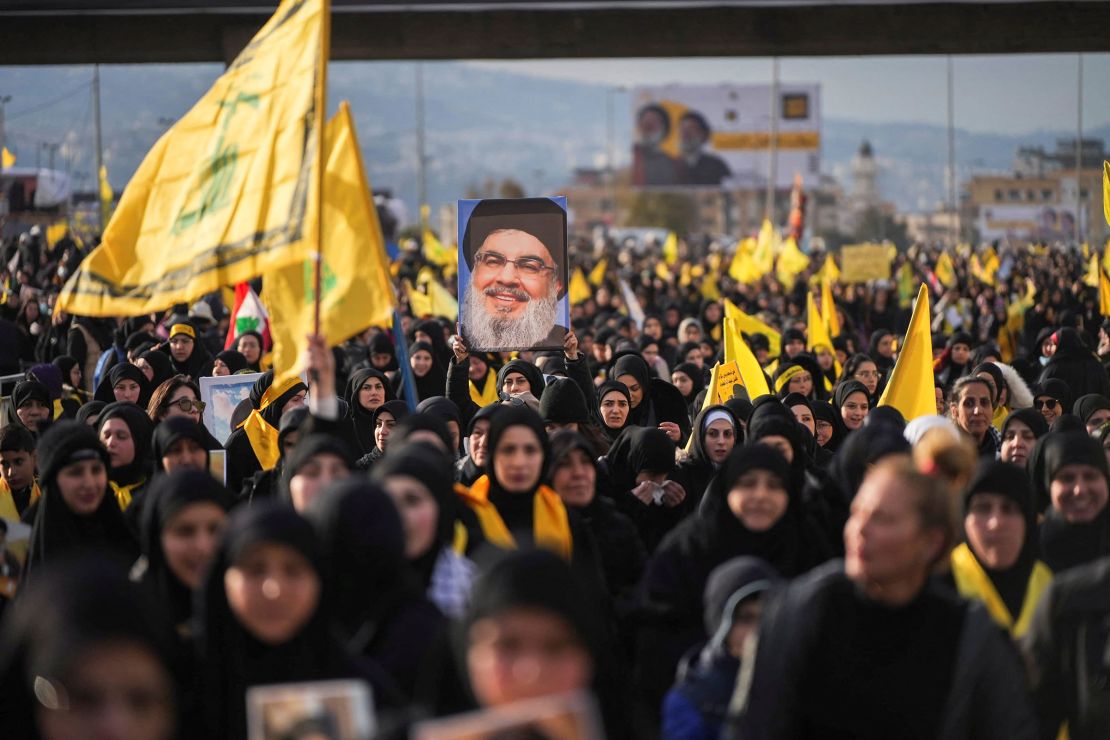 A person holds up a picture of late Hezbollah leader Hassan Nasrallah, who was killed in Israeli airstrikes last year, on the day of a public funeral ceremony in Beirut, Lebanon, on February 23.