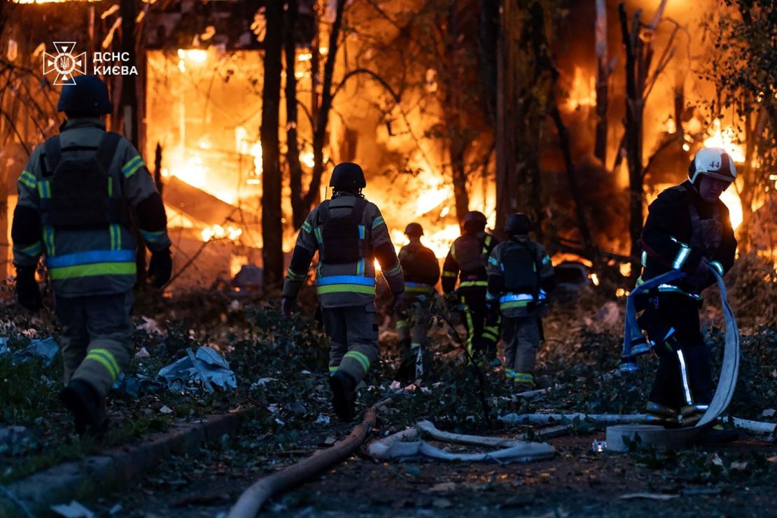 Firefighters work at the site of a Russian drone and missile strike in the Ukrainian capital on Friday.