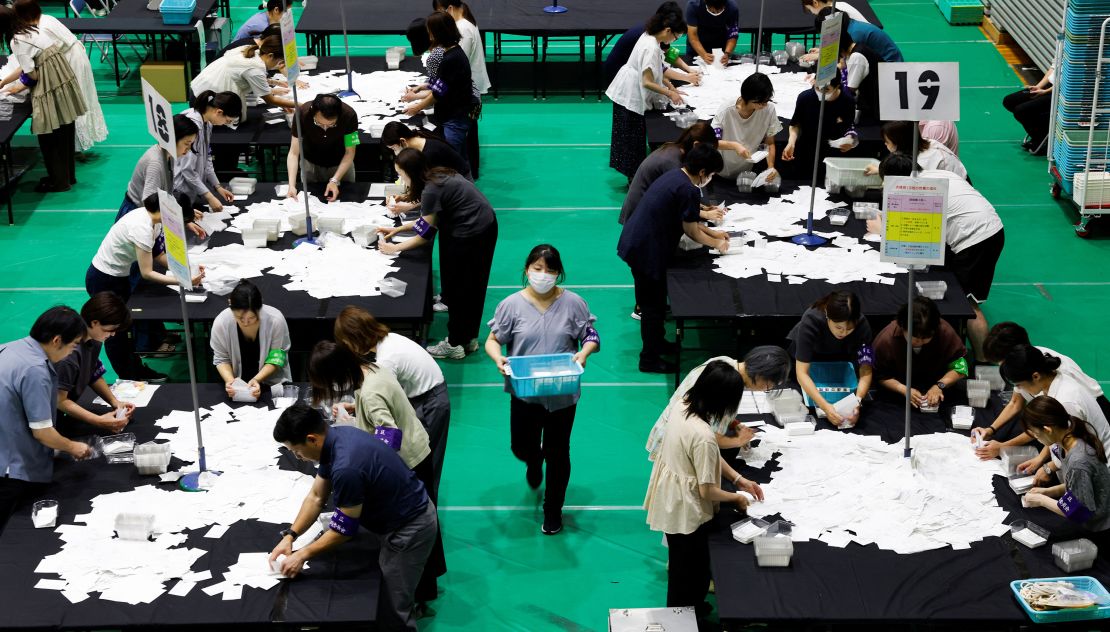 Election officials count votes for Japan's upper house election at a ballot counting center in Tokyo on Sunday.