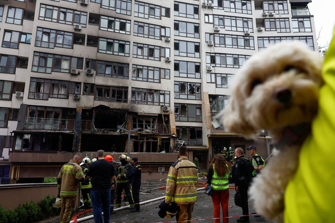 Firefighters work at the site of an apartment building hit by a Russian drone strike in Kyiv on Monday.