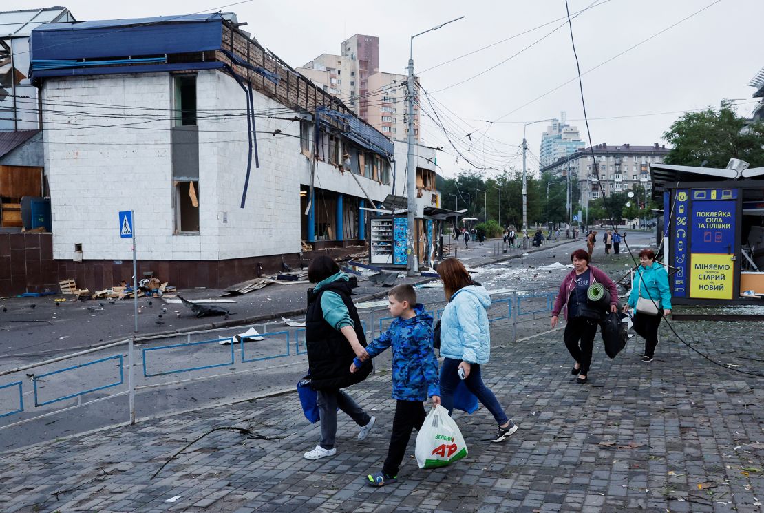 People leave a damaged metro station in Kyiv where they had been sheltering during the attack on Monday.