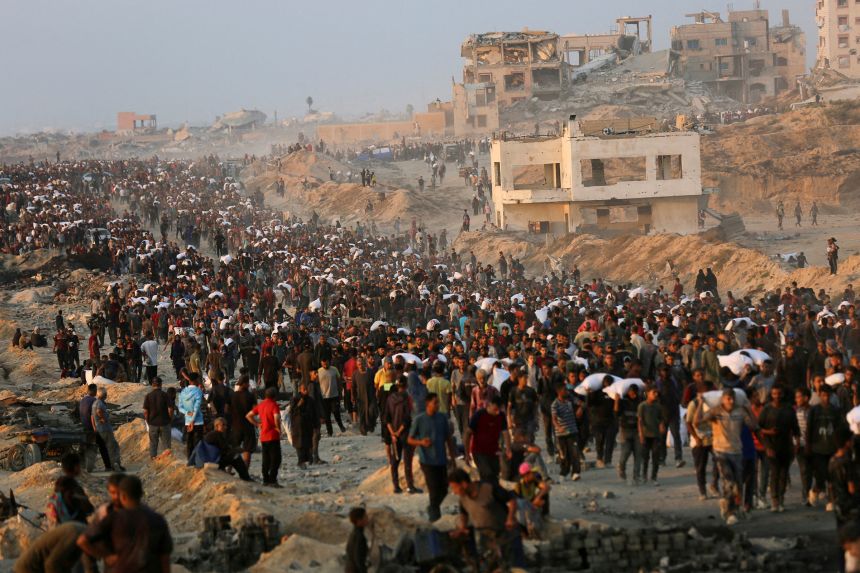 Palestinians gather to receive aid supplies in Beit Lahia, in the northern Gaza Strip, on June 17.