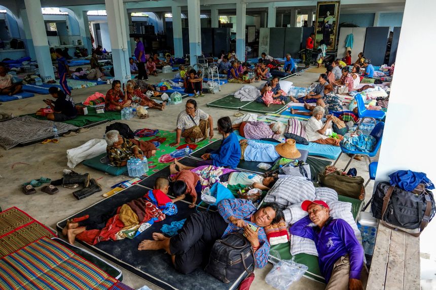 People rest at a shelter in Thailand's Surin province on July 24, after clashes broke out along the disputed Thai-Cambodian border.