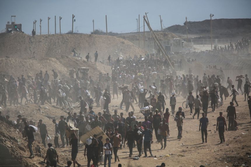 Palestinians carry aid supplies which they received from the US-backed Gaza Humanitarian Foundation, in the central Gaza Strip on July 31.