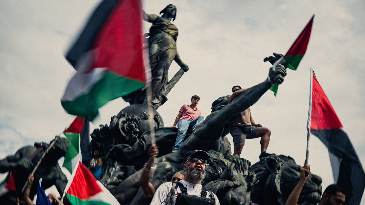 People on the Triomphe de la Republique at the Nation square with Palestine flags during a demonstration in support of Palestine called by several French trade unions in Paris France.