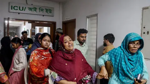 Getty Images The mother (C) of an injured student weeps inside a hospital after an Air Force training jet crashed into a school in Dhaka on July 21, 2025