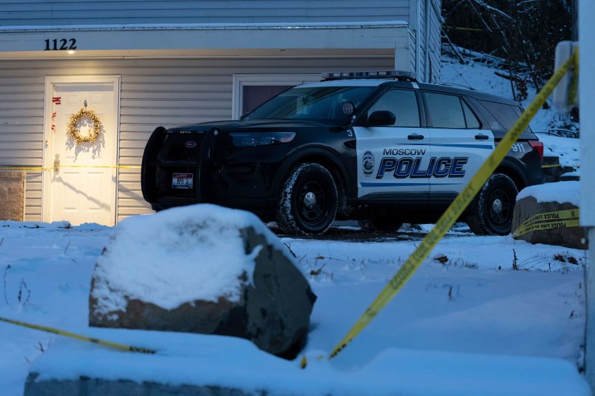 A Moscow police officer stands guard in his vehicle, Tuesday, Nov. 29, 2022, at the home where four University of Idaho students were found dead on Nov. 13, 2022 in Moscow, Idaho. The university will be holding a system-wide vigil on Wednesday evening, Nov. 30, 2022, in memory of the students, as investigators continue to look for a suspect and motive in the killings. (AP Photo/Ted S. Warren)