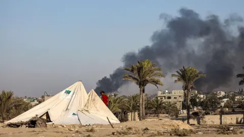 Anadolu via Getty Images Smoke rises over western Deir al-Balah, central Gaza (21 July 2025)