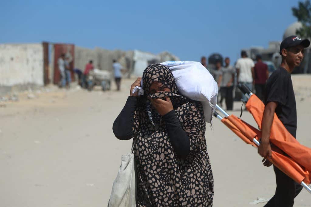 Palestinian women come back from GHF distribution center in southern Gaza, where eyewitnesses say GHF staff pepper-sprayed the aid-seekers and beat them with batons, July 24, 2025. (Photo: Abdallah Alattar/APA Images)