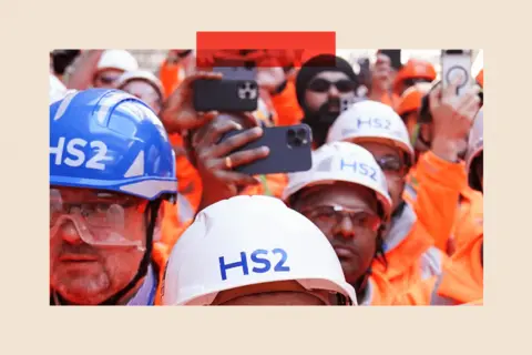 PA Media HS2 workers gather to observe a machine breaking through at Washwood Heath depot