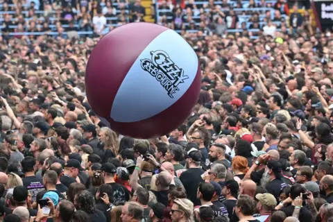 Getty Images A beach-ball bounces over the head of crowds of concert-goers at the gig
