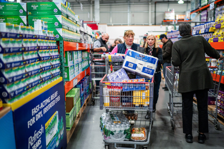 Customers shop in an aisle at the store