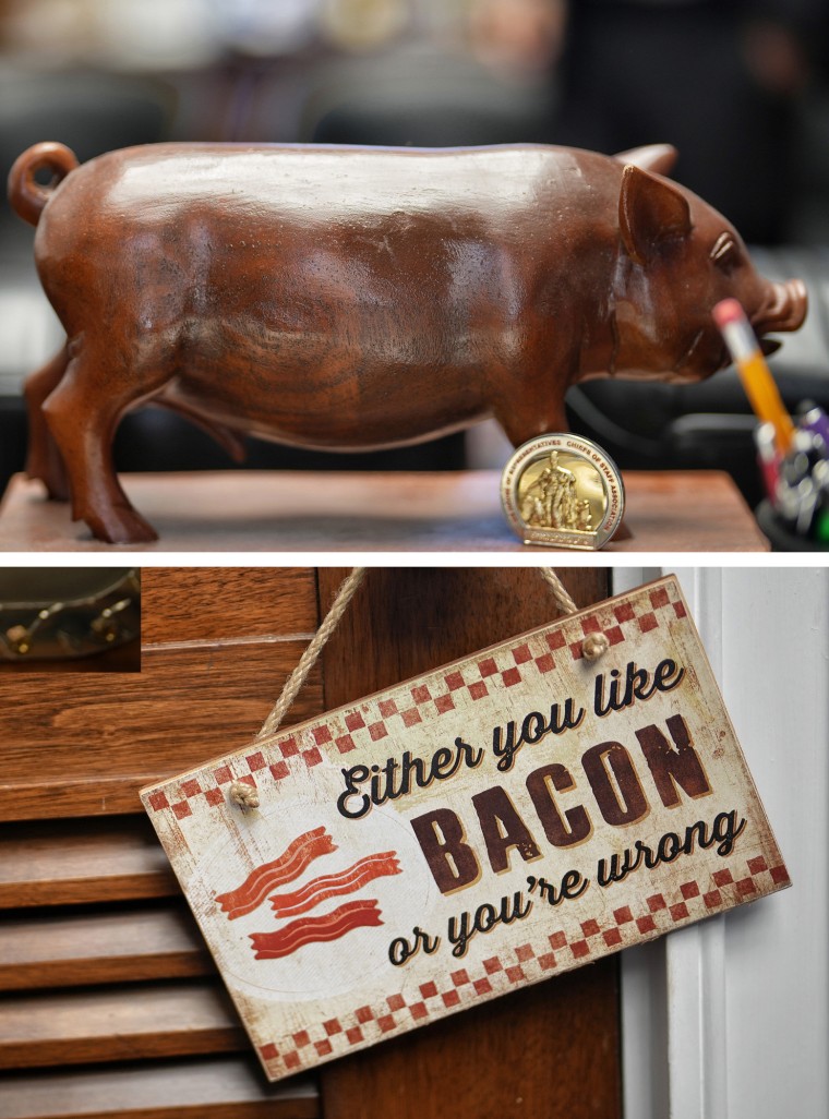 A diptych of a wooden pig and a sign that reads " Either you like bacon or you're wrong" in Don Bacon's office on Capitol Hill.