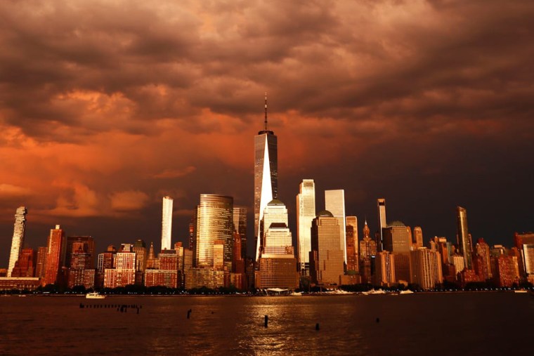 Clouds pass over the skyline of lower Manhattan and One World Trade Center as the sun sets following a storm in New York City on Thursday, as seen from Jersey City, New Jersey.