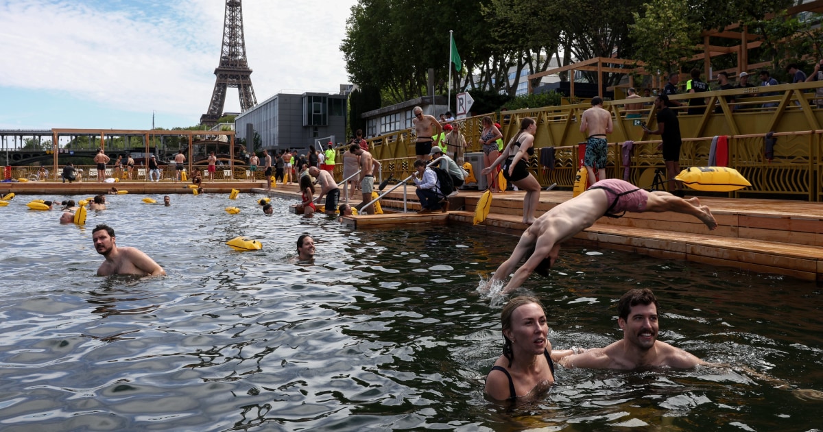 Joyful Parisians take a historic plunge into the Seine after 100 years