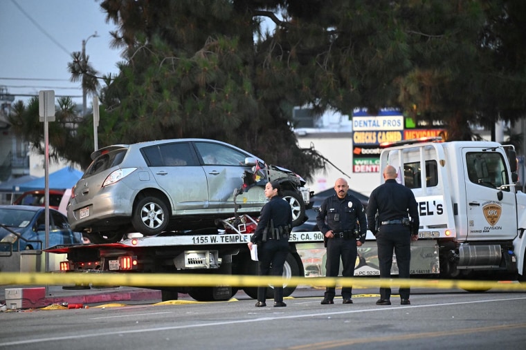 A vehicle is taken away on a truck after it drove into a crowd in Hollywood