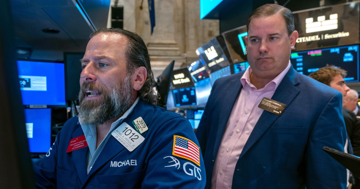 Wall Street edges back from its records as a busy week picks up momentum