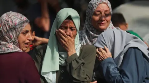Reuters Palestinian women react during the funeral of people killed in Israeli strikes in Gaza City (21/07/25)