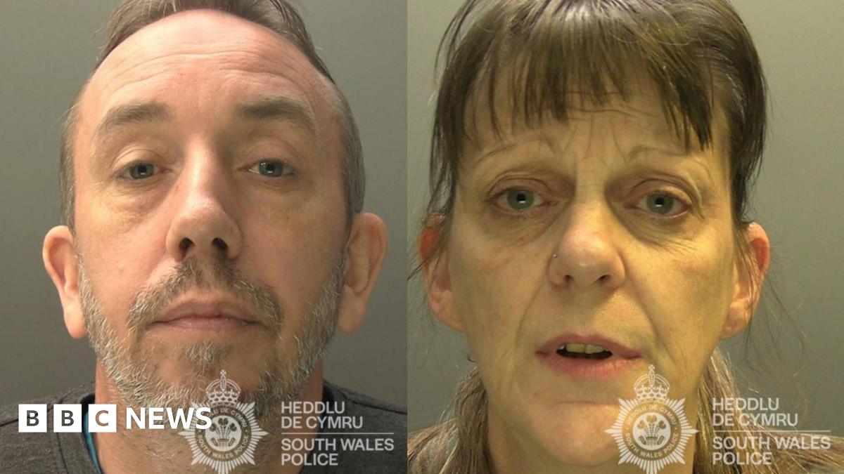 Headshot photograph of Tracy Turner(right) and Stuart Compton(left). Stuart has a grey beard, blue eyes and a receding hairline. Tracy has a brown fringe and blue eyes.