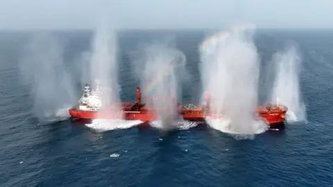 EPA Screenshot of a video released by Yemen's Houthis that appears to show explosive charges being detonated on the cargo ship Magic Seas after armed men boarded the vessel (8 July 2025)