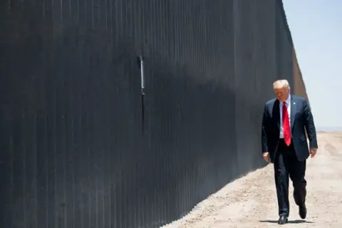 Getty Images Trump at the border wall in Arizona