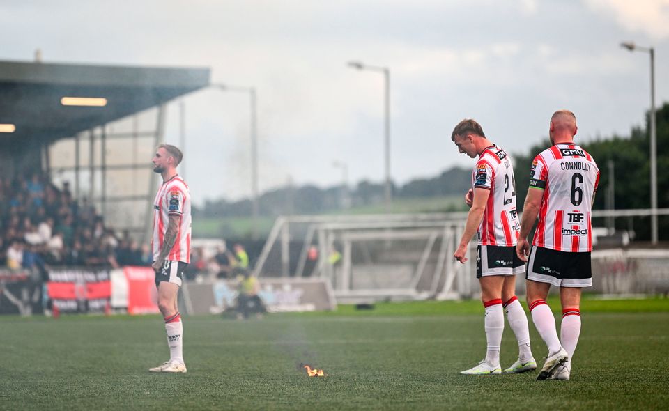 Derry City players Carl Winchester, Sam Todd and Mark Connolly after a flare was thrown onto the pitch during the SSE Airtricity Men's Premier Division match between Derry City and Bohemians at The Ryan McBride Brandywell Stadium in Derry. Photo: Ramsey Cardy/Sportsfile