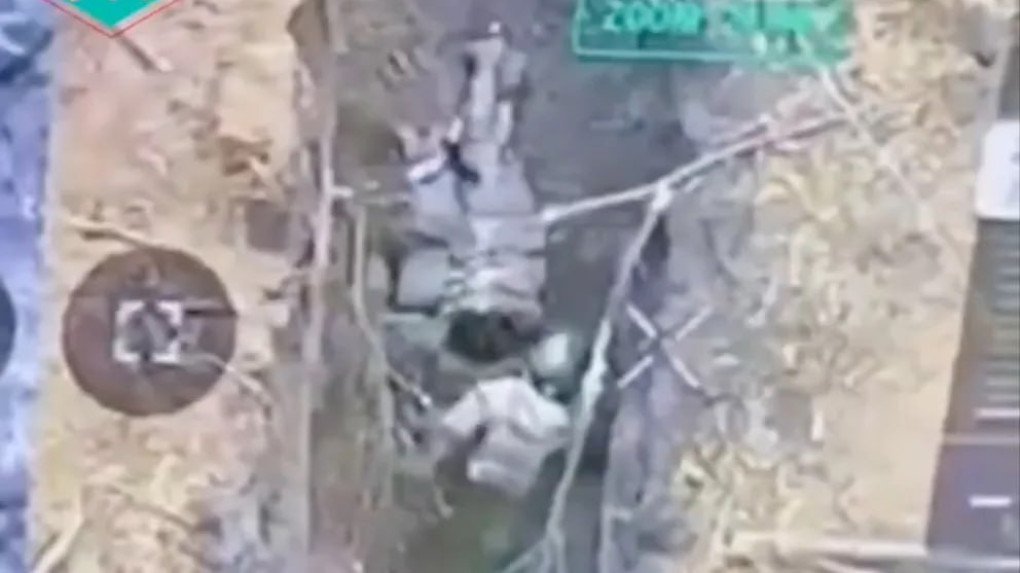 Drone footage shows a Russian soldier in a trench inspecting and attacking an injured fellow serviceman. (Source: BILD)