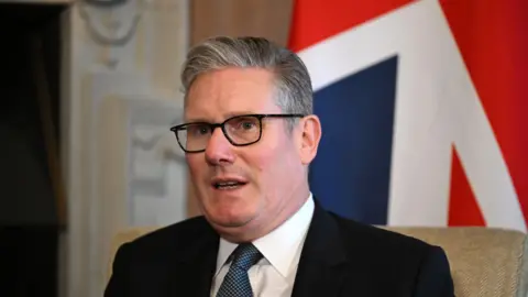 EPA Keir Starmer sitting in front of a union flag 