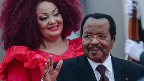 AFP via Getty Images. Chantal Biya (L) and Paul Biya (R) on a visit to China last year.