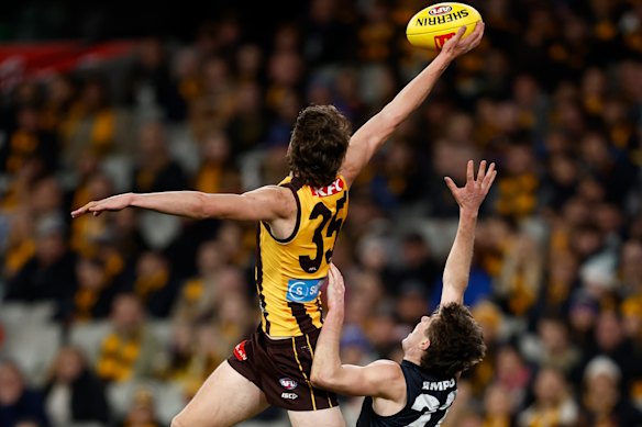 Calsher Dear of the Hawks takes a spectacular mark over Harry O’Farrell of the Blues.