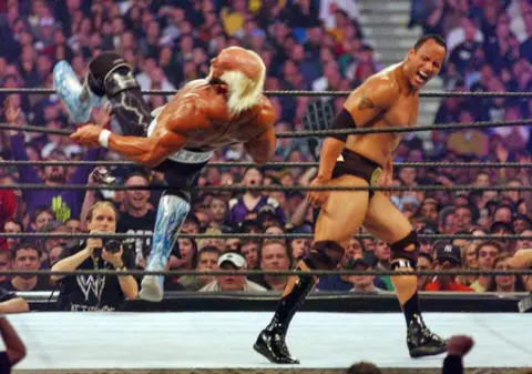 Getty Images Hulk is falling backwards over the top rope as The Rock walks away with his ecpression in a triumphant scream at Wrestlemania X8 in 2002