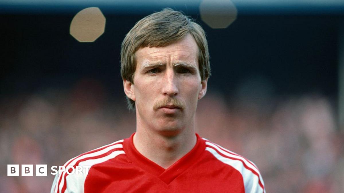 Sarina Wiegman looks forward with a fixed expression