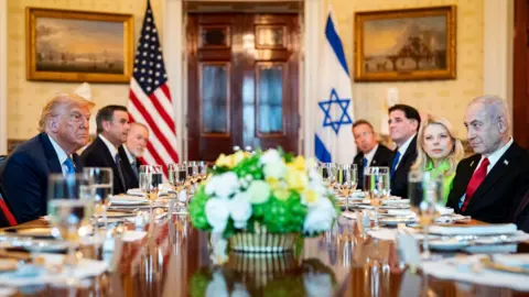 EPA US President Donald Trump (L) and Israeli Prime Minister Benjamin Netanyahu (R) converse during a dinner in the Blue Room of the White House in Washington DC (7 July 2025)