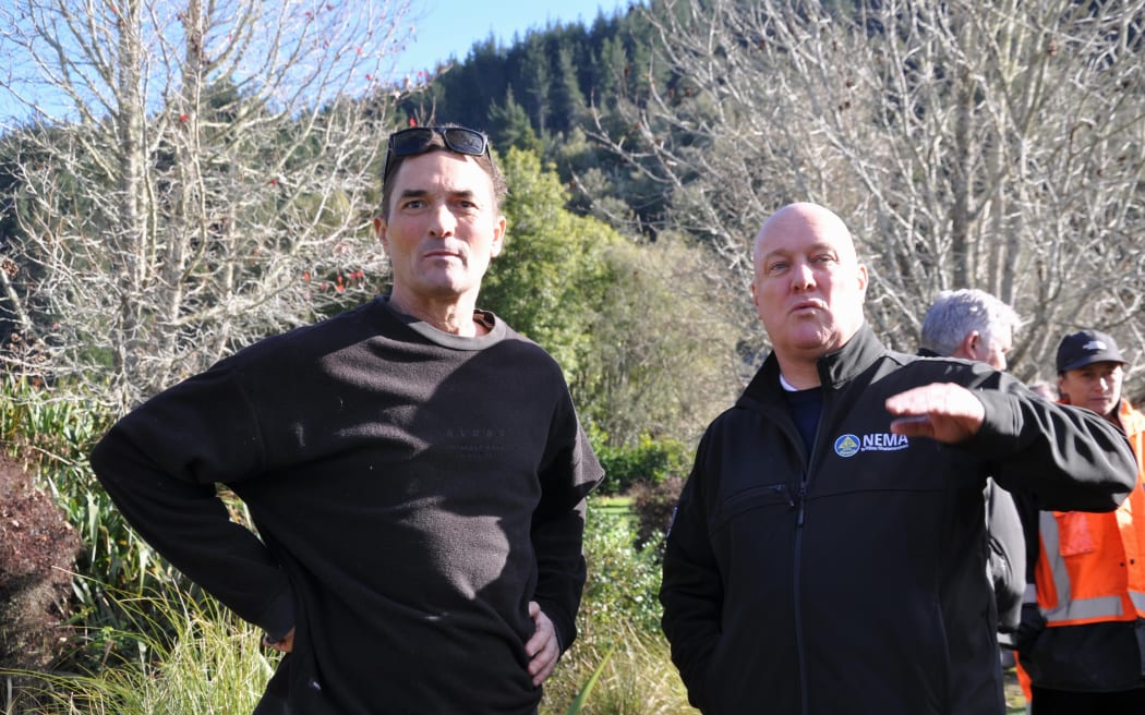 Mill Creek Orchard owner Donald Heckler right showing Prime Minister Christopher Luxon the damage to his blueberry farm after two floods in the Tasman District.