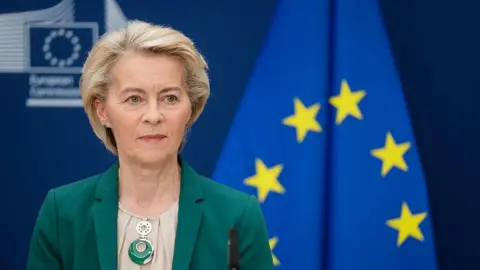 Getty Images European Commission President Ursula von der Leyen sitting in front of the EU flag