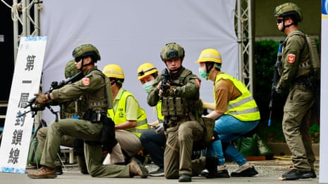 Shoppers and commuters take shelter in air-raid drill in Taipei – video