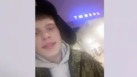 Vitaly Ivanov/VK A young man wearing a Russian hat and a khaki top