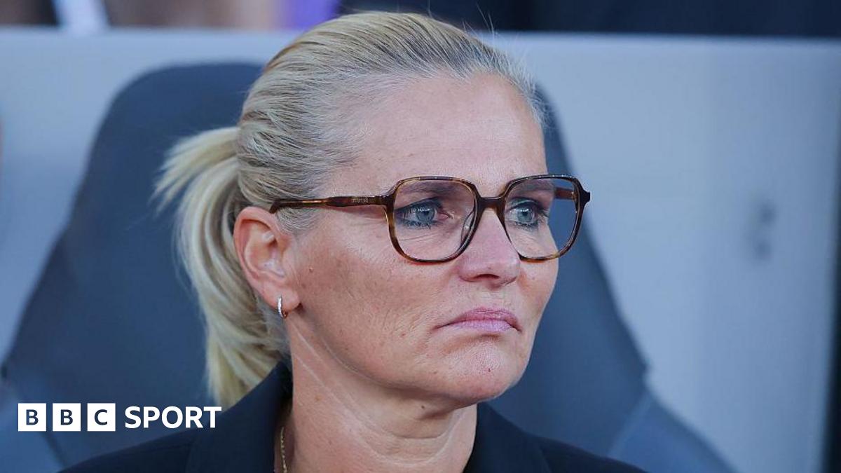 Sarina Wiegman looks forward with a fixed expression