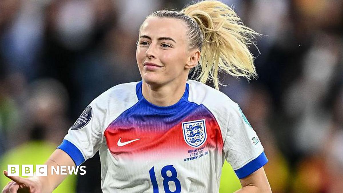 England footballer Chloe Kelly gestures while celebrating during a match, wearing the number 18 shirt of the national team.