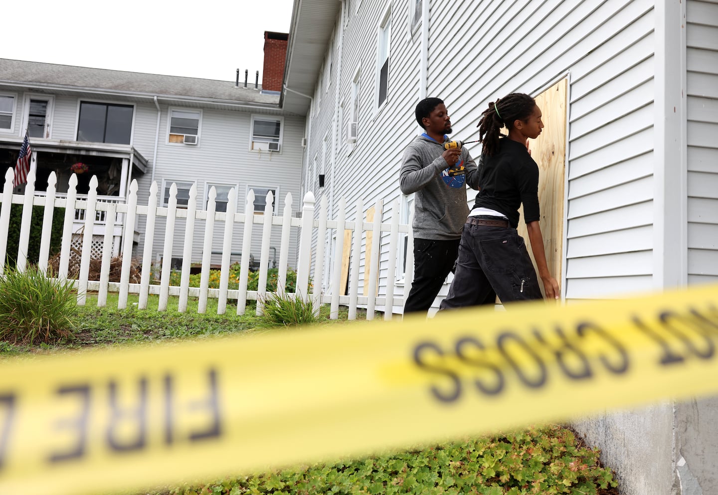 Workers board up the Gabriel House Assisted Living Facility after a fire there killed 9 people  in Fall River, MA on July 14, 2025.