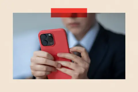 Matt Cardy/Getty Images A school boy looks at a Phone screen
