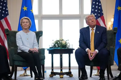 Getty Images Ursula von der Leyen and President Donald Trump sitting on two green velvet chairs looking each in a different direction