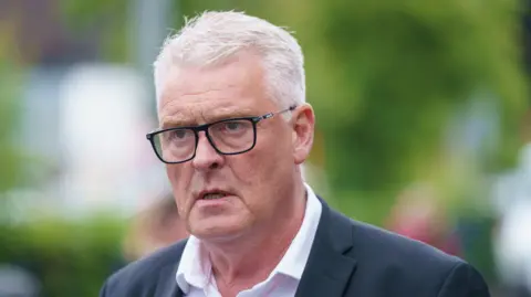 PA Media Reform MP Lee Anderson wears glasses, a grey suit jacket and a white shirt.