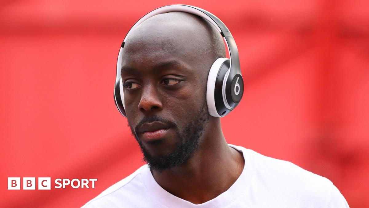 Sarina Wiegman looks forward with a fixed expression