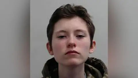 Police Scotland A mugshot of Felix Winter, who has dark hair and appears to be wearing a camouflage jacket with the hood down