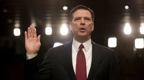 Getty Images Former FBI Director James Comey is sworn in while testifying before the Senate Intelligence Committee on 8 June 2017 